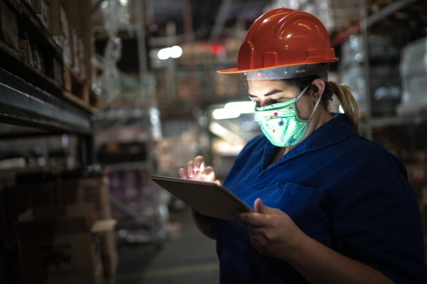 Woman using digital tablet at a warehousery